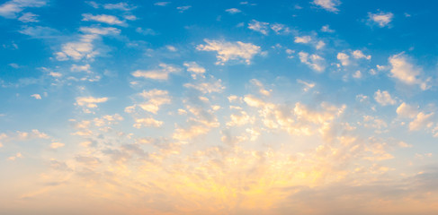 Naklejka na ściany i meble Beautiful Vivid sky painted by the sun leaving bright golden shades.Dense clouds in twilight sky in winter evening.Image of cloud sky on evening time.Evening Vivid sky with clouds.
