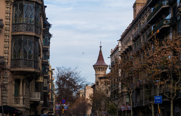 Fototapeta premium Buildings in streets of Barcelona with a tower in background