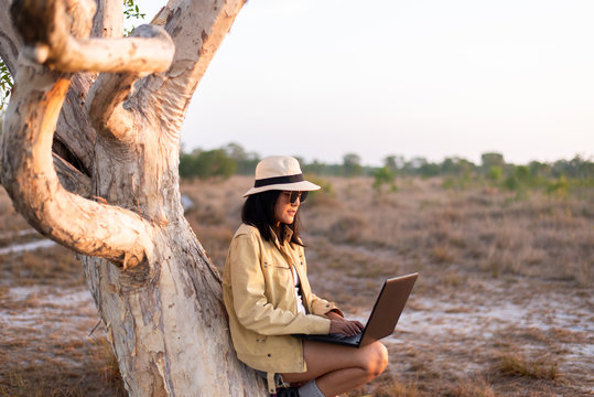 Solo Traveller Asian Women Tourist Using Internet With Laptop Computer At Forest,Travel And Vacation Concept