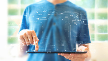 Technology screen with young man using a tablet computer