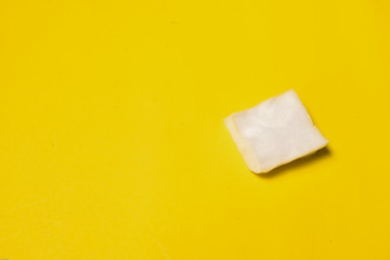 One cotton pad isolated on yellow background
