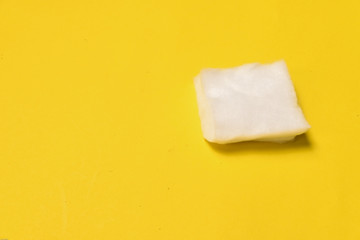 One cotton pad isolated on yellow background