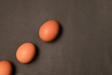 Three chicken eggs isolated on black background