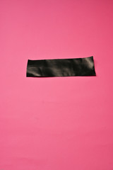 Black duct tape isolated on colorful background