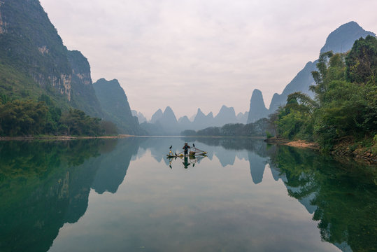 Chinese traditional living habits, images of traveling in Guilin, China, a fisherman relaxing on the Li River.