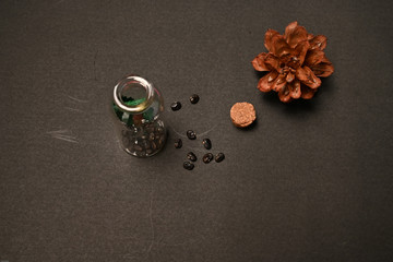 Dried seeds of telang flower ( clitoria ternatea L. ) were put inside and outside bottle isolated on black background 