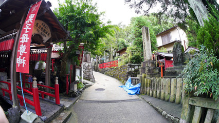 Fototapeta na wymiar inside the Fushimi Inari Taisha Shinto shrine which is famous for its thousands of vermilion torii gates along the trails to the sacred Mount Inari, 