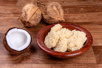 Delicious cocada. Brazilian coconut candy on wooden table