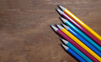 Fototapeta premium Colored pencils on horizontal wooden background.