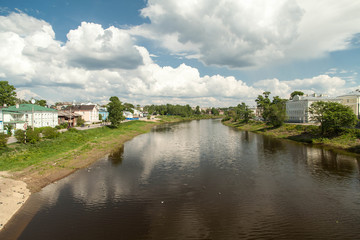 Obraz premium Summer russian river townscape of green embankment