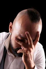 Fototapeta premium Close-up portrait of a depressed young caucasian male weeping with eyes closed