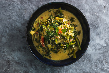 plant-based food,  vegan green curry with spinach broccolini kale and stir fry vegetables
