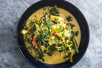 plant-based food,  vegan green curry with spinach broccolini kale and stir fry vegetables