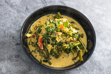 plant-based food,  vegan green curry with spinach broccolini kale and stir fry vegetables