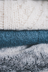 winter lifestyle concept, soft and fluffy blankets and throws stack