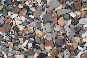 Multicolored colorful sea pebbles, natural background, texture. Close-up texture of colorful sea pebbles. Small Rock. Sea background