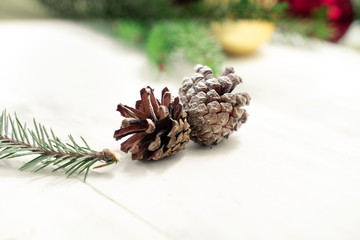 pine cones and branches and Christmas balls on a light wooden background. christmas background