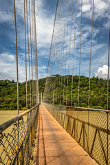 Obraz premium suspension iron bridge isolated with bright blue sky from unique different angle