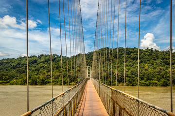 suspension iron bridge isolated with bright blue sky from unique different angle