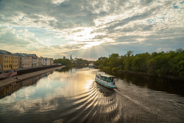 Fototapeta premium Summer townscape with motor ship on a river
