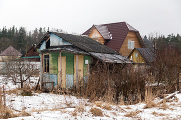 Russian village house next to a spring road