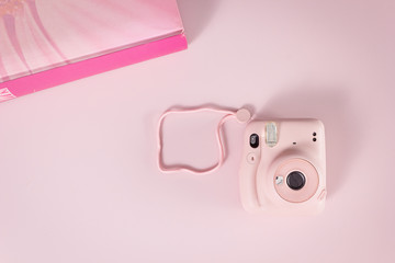compact camera on pink background