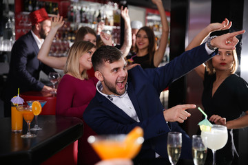 Young happy man having fun at nightclub