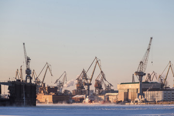 Large industrial cranes of the admiralty shipyards in saint petersburg in winter