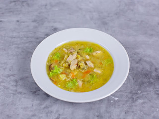 Chicken soup on a white plate