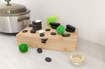 Obraz na płótnie Canvas Hot stone massage. Close up pile of spa stones with aroma oil still life 