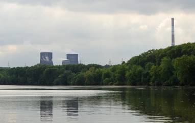 Obraz premium Industry and nature. Environmental pollution. Thermal power plant with huge chimneys. Selective focus blur.