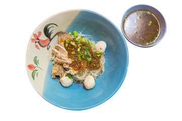 Close up of noodles with pork and pork balls with soup die cut on white isolated, focus selective.