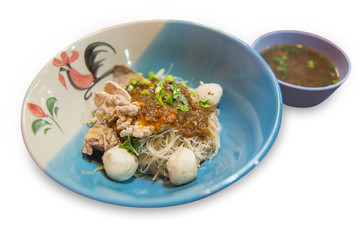 Close up of noodles with pork and pork balls with soup die cut on white isolated, focus selective.