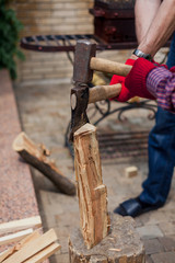 Two people prick log on stump closeup