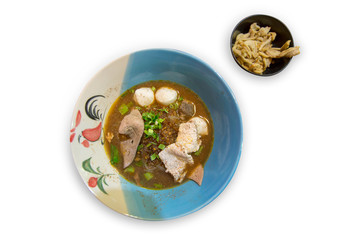 Close up of noodles with pork and pork balls with soup die cut on white isolated, focus selective.