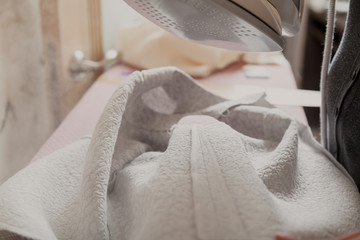Smoothing seam of garment with modern iron
