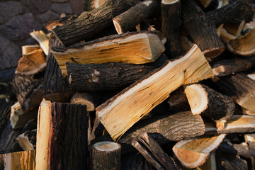 Firewood of different shapes piled up in bunch close up