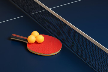 Table tennis bat or ping pong rackets and balls with a net on the table.