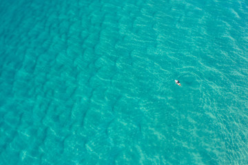 Aerial view surfers at Alexandra Bay, Noosa National Park