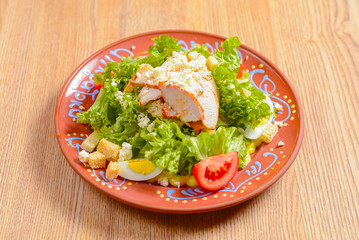 Appetizing salad with vegetables, meat and fresh greenery. Caesar salad. Ukrainian cuisine concept, food in Ukraine.