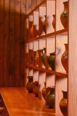 Obraz na płótnie Canvas Clay jugs, old ceramic vases on a shelf. Beautiful hand made jugs. Ukrainian style, Ukraine concept.