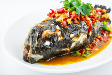 Braised grouper in a dish of Chinese cuisine on white background