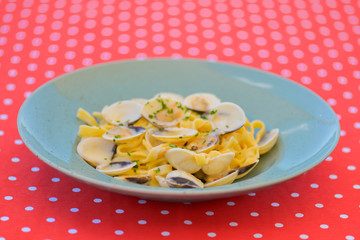 Linguine with clams. Traditional Italian pasta with clams and other sea food. Healthy meal. Eating out in restaurant.