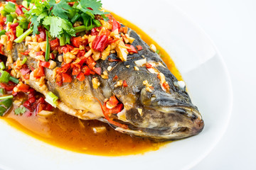 Braised grouper in a dish of Chinese cuisine on white background
