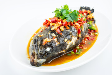Braised grouper in a dish of Chinese cuisine on white background