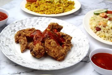 Freshly cooked deep fried crispy chicken wings on a plate
