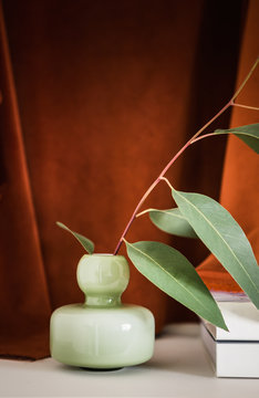 Still Life Of A Green Glass Vase And Gum Leaves