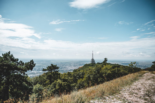 View of TV, radio and BTS tower called Pyramida from Zobor hill, center of Nitra city and rapeseed fields in background. Location Zobor hill, Nitra, western Slovakia