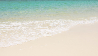 Fototapeta na wymiar Blue sea ocean, water sun reflection, and sand background.