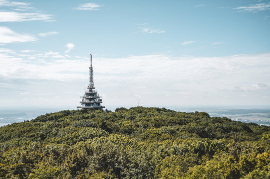 View of TV, radio and BTS tower called Pyramida from Zobor hill, center of Nitra city and rapeseed fields in background. Location Zobor hill, Nitra, western Slovakia